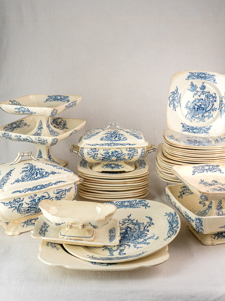 40-piece antique French Clairefontaine faience dinnerware set with blue floral motifs on white ceramic.