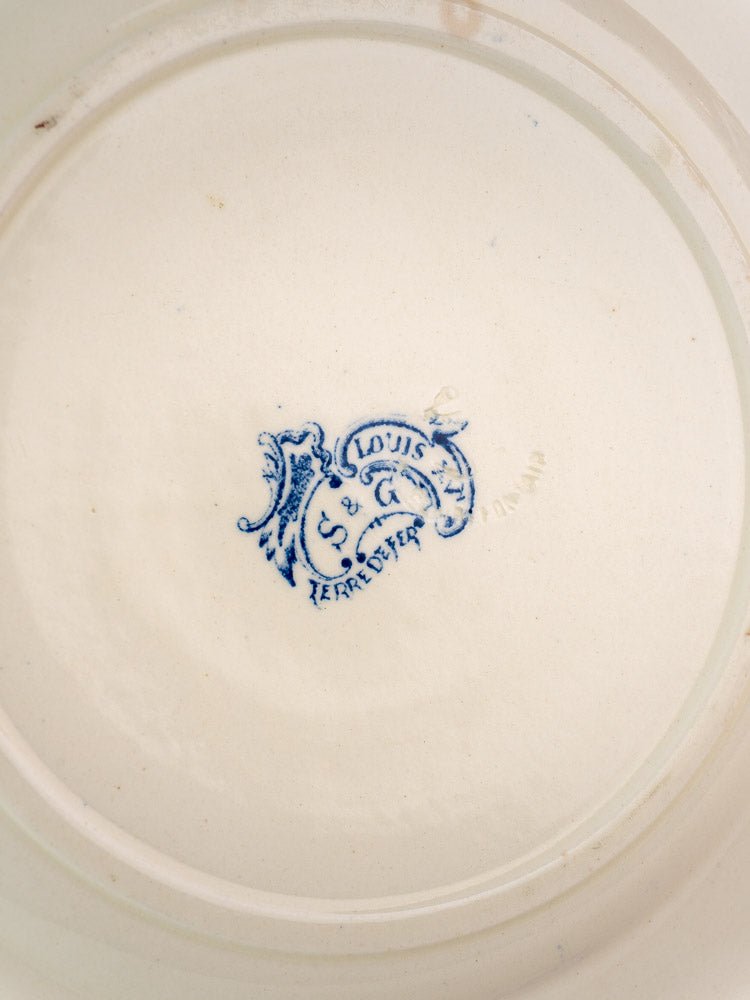 Underside of Clairefontaine faience plate with ornate blue “St. Louis Terre de Fer” and faint “FRANCE” stamp.