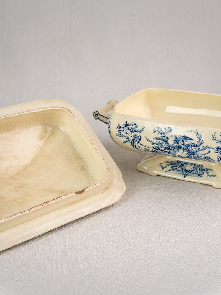 Antique French Clairefontaine faience dishes: cream-toned with crazing and blue floral-bird transferware.