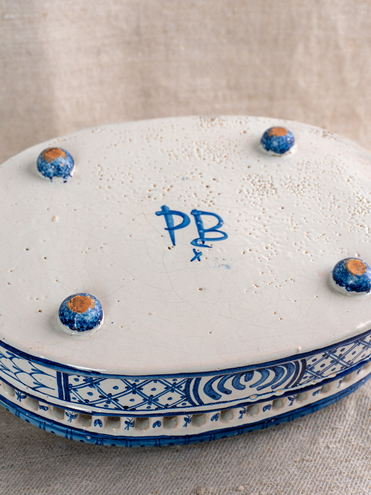 Antique French faience jardinière, cobalt blue tin glaze, hand-painted, oval form, four feet, PBx initials; beige fabric background.
