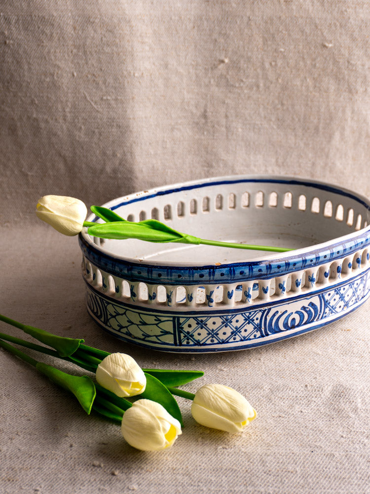 Antique French faience jardinière by Pouplard Béatrix with cobalt blue patterns, on neutral fabric background.