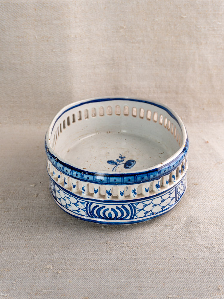 Antique French faience jardinière with cobalt blue tin glaze, floral motifs, geometric accents, and pierced rim.