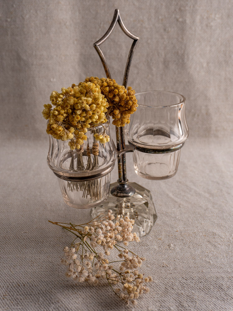 Antique French silver plate and cut glass condiment server with yellow and white dried flowers.