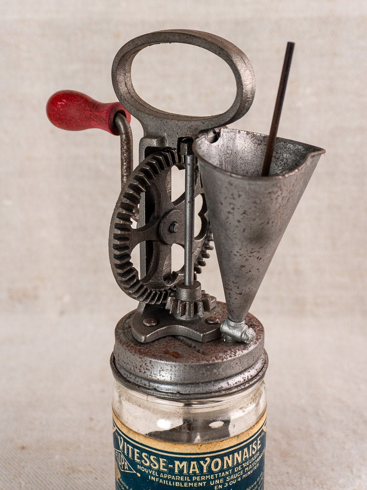 Antique French Vitesse Baratte mayonnaise maker with metal gears and handle on glass jar, c. 1920s.