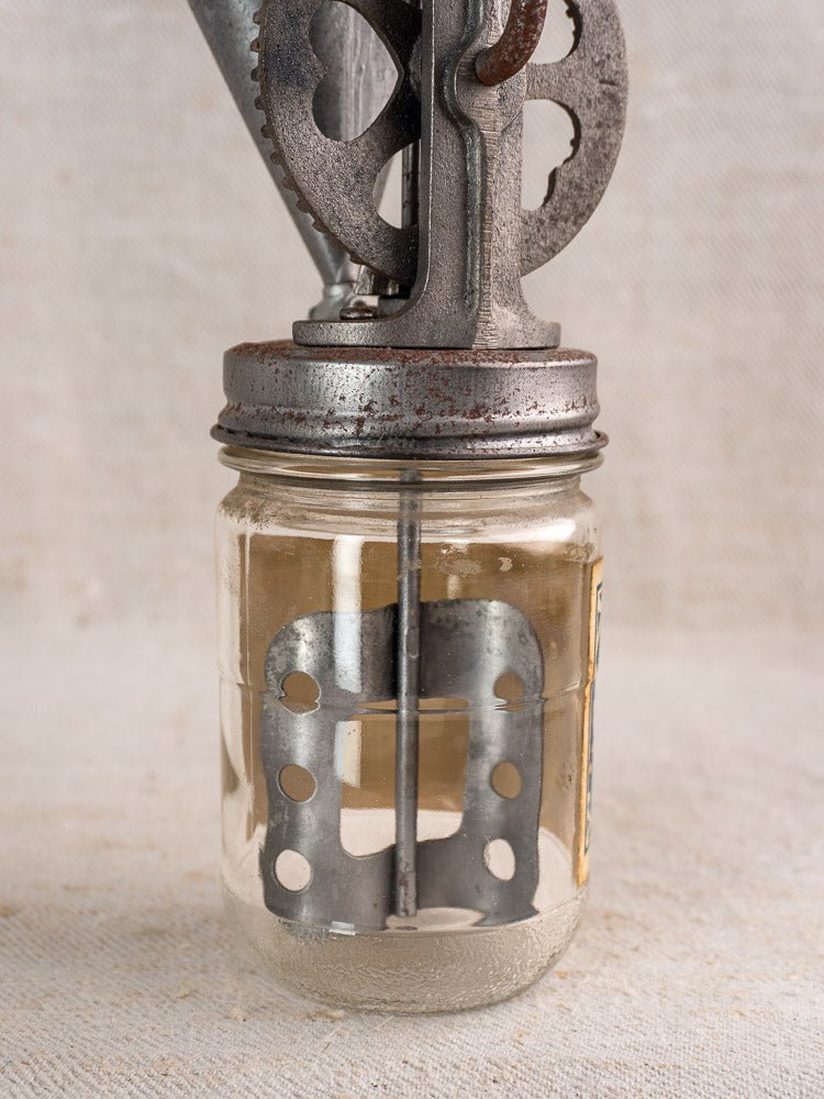 Antique French FUPA Vitesse Baratte mayonnaise maker, 1920s, with metal hand-crank and clear glass jar.
