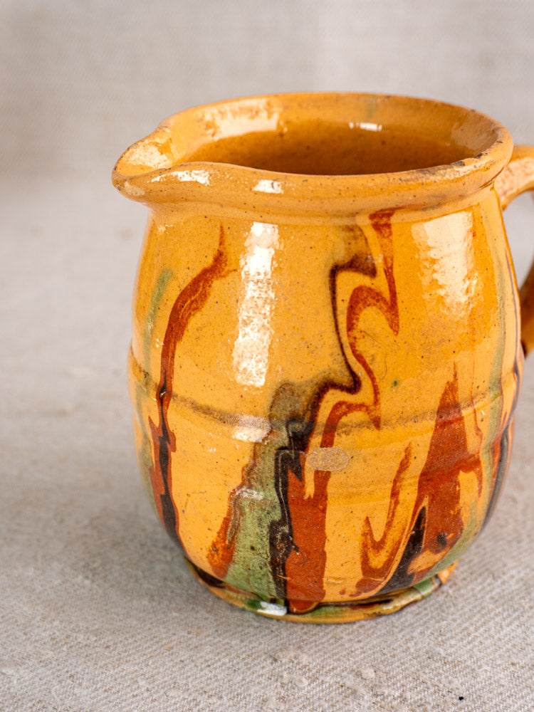 Antique French Jaspé pitcher, small yellow ceramic jug with marbled slip glaze, classic spout and handle design.