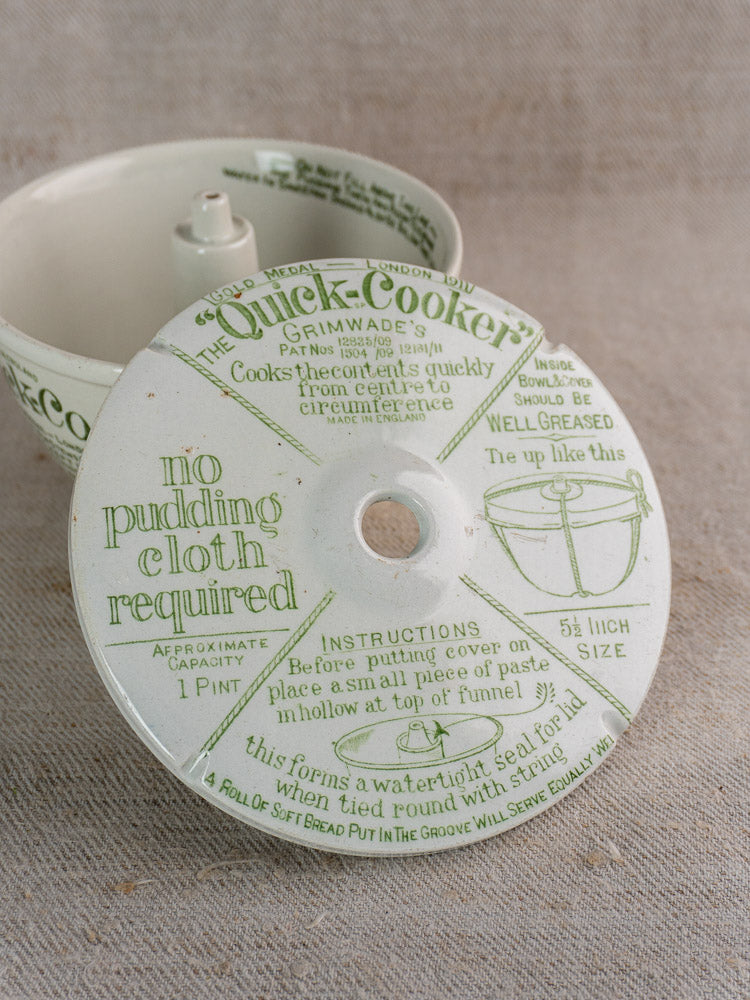 Ceramic lid with green instructions and funnel opening, matching bowl behind, Antique English Pudding Steamer, c.1911.