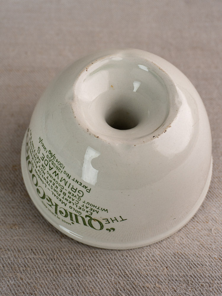 Antique English white ironstone pudding steamer, Grimwade Quick Cooker c.1911, upside down on beige fabric.