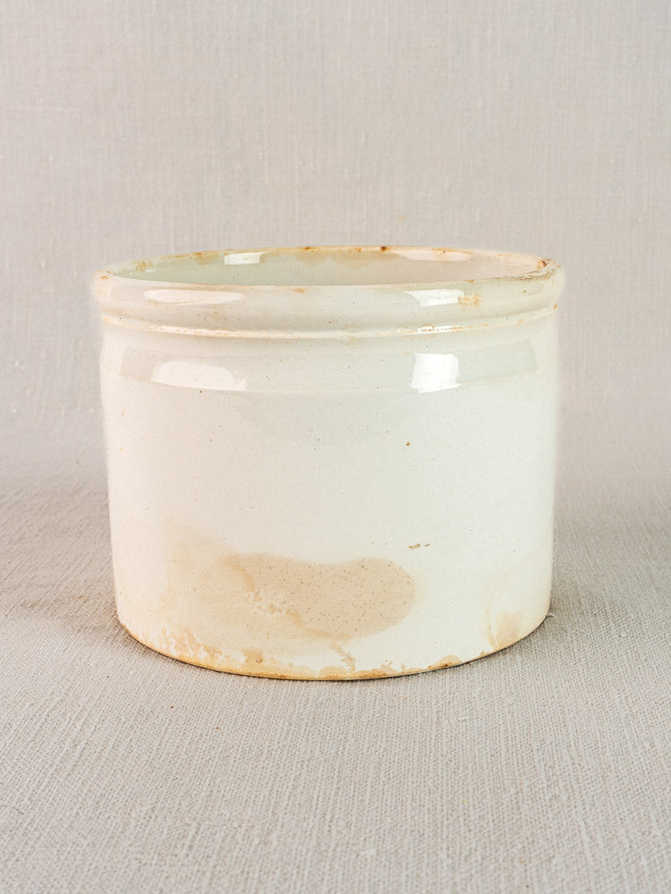 Antique French Fenal Badonviller rillettes pot in white ironstone with cream hue and aged patina.