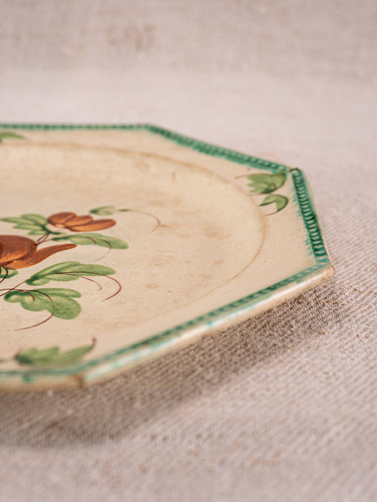 Antique French faience plate with octagonal ceramic form, green beaded rim, and hand-painted fruit motifs on beige textured surface.