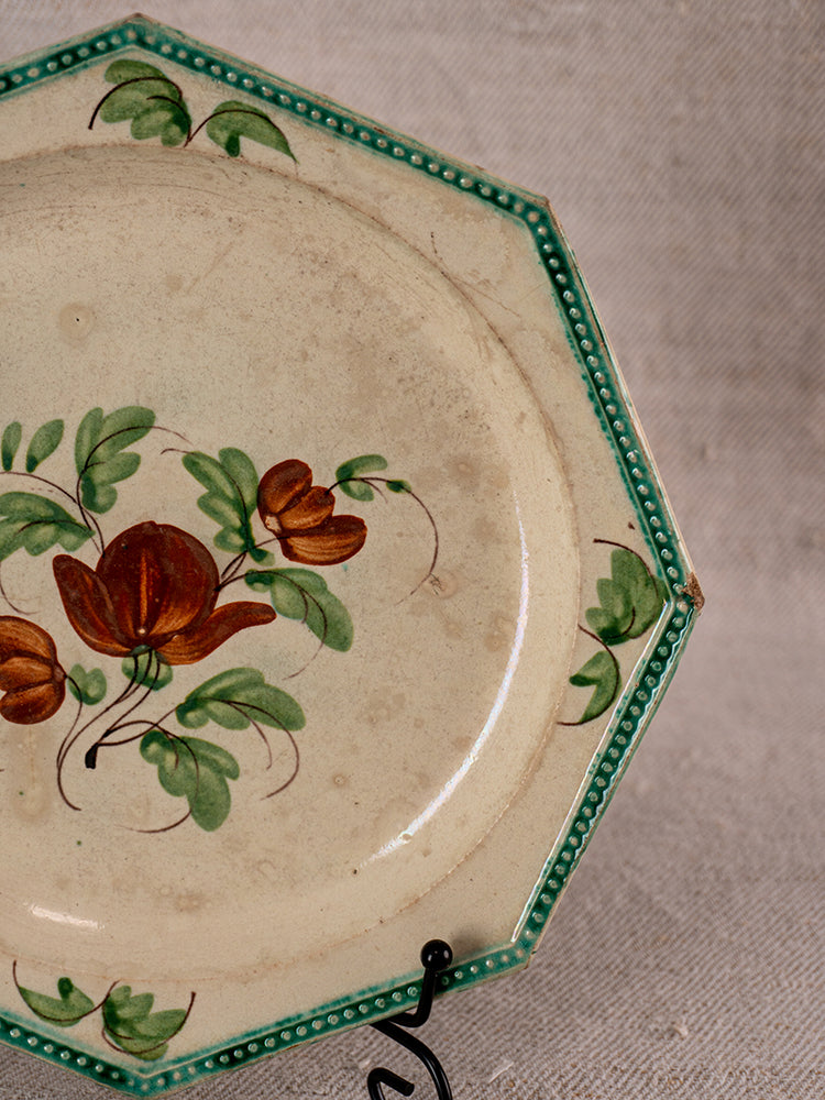 Antique French faience plate with octagonal ceramic form, green beaded rim, and floral design.