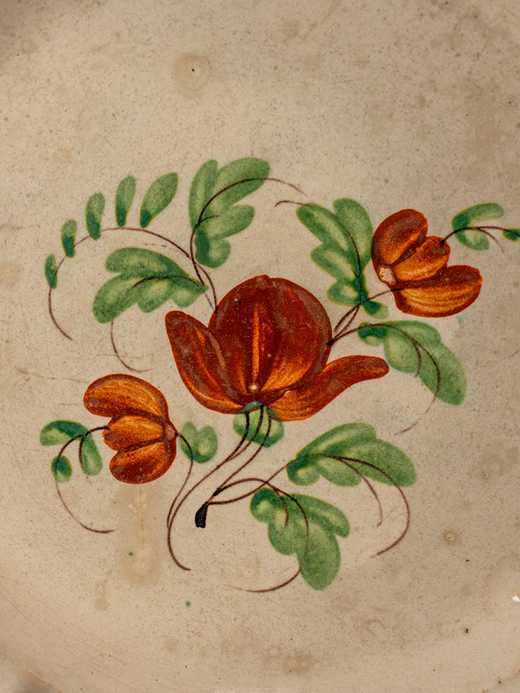 Antique French faience plate with beaded rim, hand-painted orange-red flowers, Normandy earthenware style.