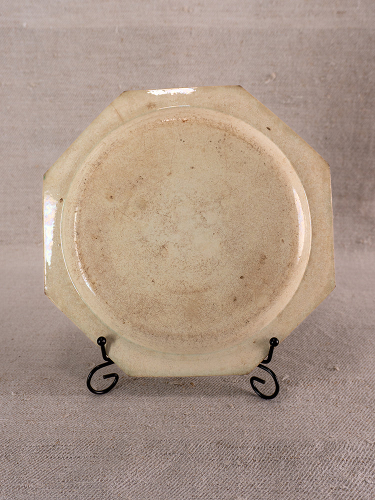 Antique French faience plate from Aumale with beaded rim, octagonal form, rustic finish, on stand.