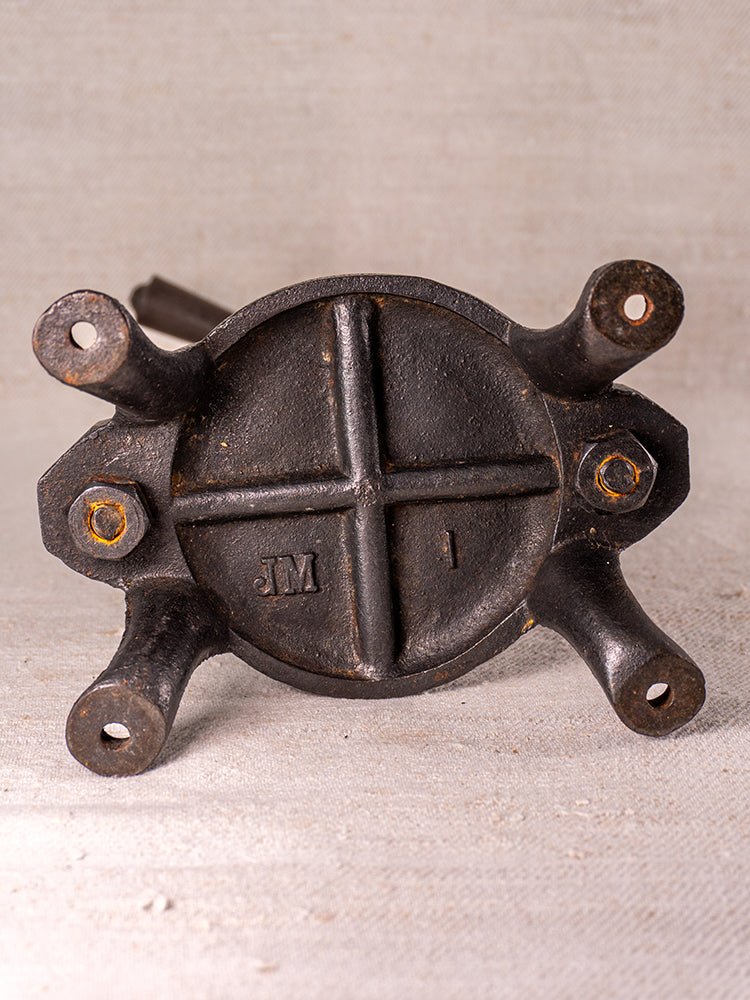 Antique French cast iron fruit press, blue enamel accents, embossed “JM” and “1” on cross-patterned base.