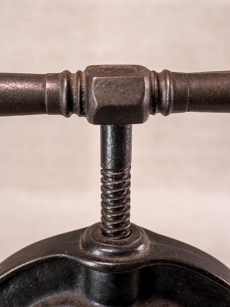 Antique French cast iron fruit press with blue enamel, circa 1900, horizontal handle and threaded rod.