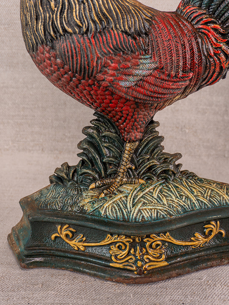 Antique French cast iron rooster doorstop, polychrome finish with red, green, and gold on ornate base, late 19th century.