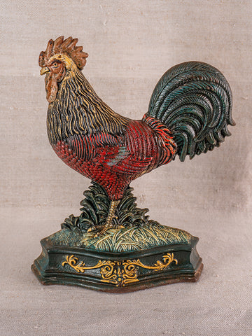Antique French cast iron rooster doorstop with detailed red, brown, and green feathers on ornate green-gold base.