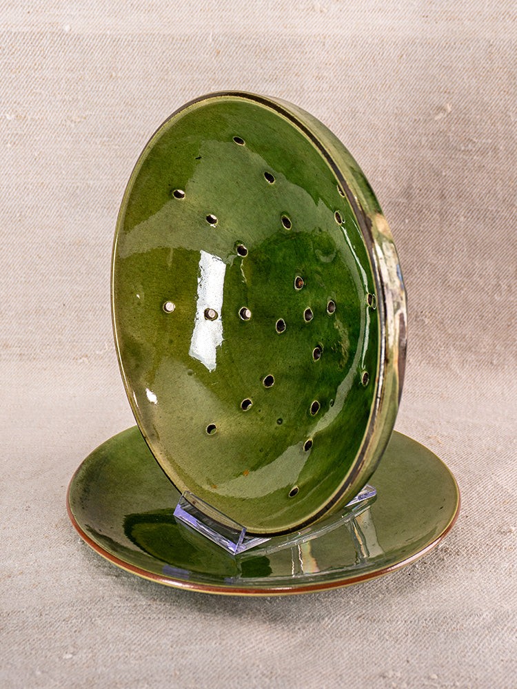 Mid-20th century French green glazed earthenware berry drainer set with matching plate on clear stands.