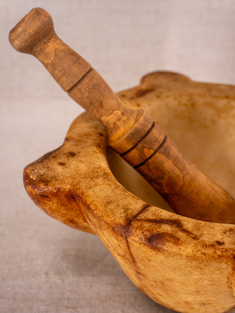 Antique French marble mortar and pestle with Provencal silhouette displayed on a light surface, 18th century.