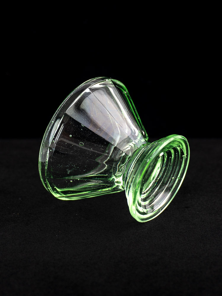 Antique French Art Deco uranium glass sherbet coupe with clear green tint and wide bowl displayed on black background.