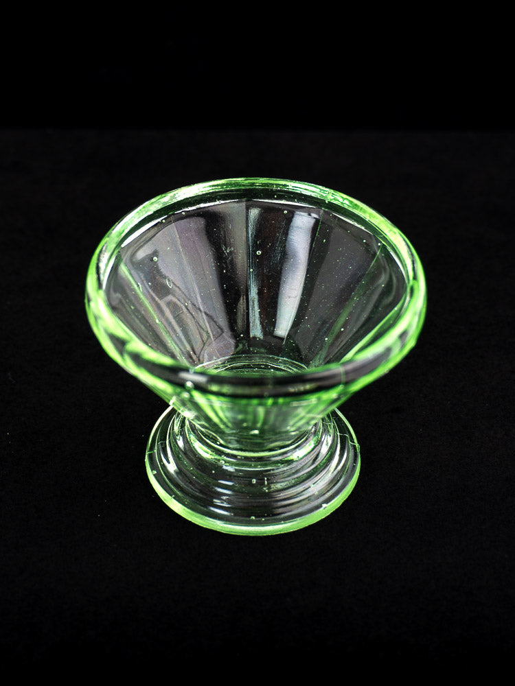 Set of 12 antique French Art Deco uranium glass sherbet coupes with flared rims, shown on a black background.