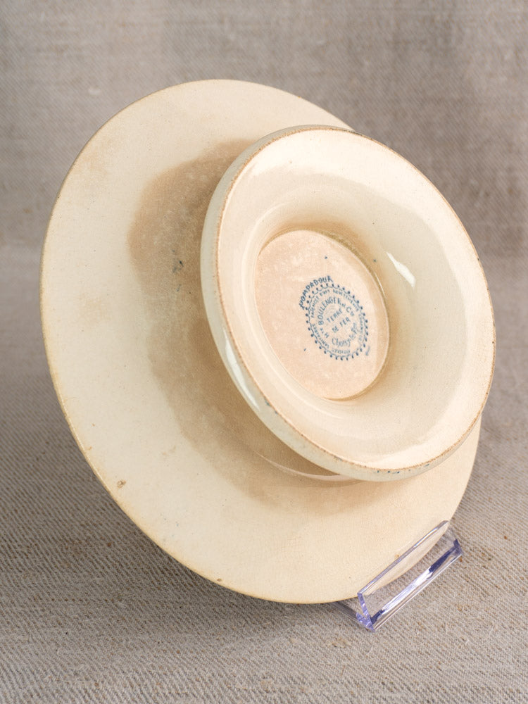 Antique French Boulenger Choisy-le-Roi compote plate, Pompadour pattern, cream faience with blue mark, light wear on textured beige fabric.