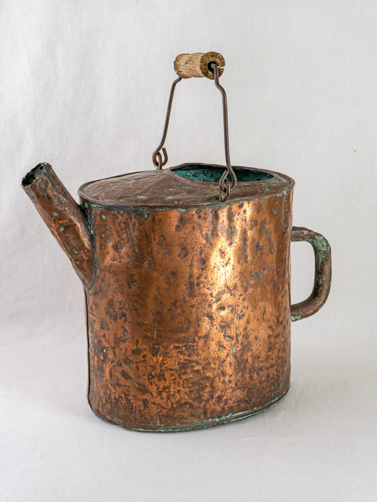 19th-century French hammered copper water carrier with angled spout and cork grip handle.