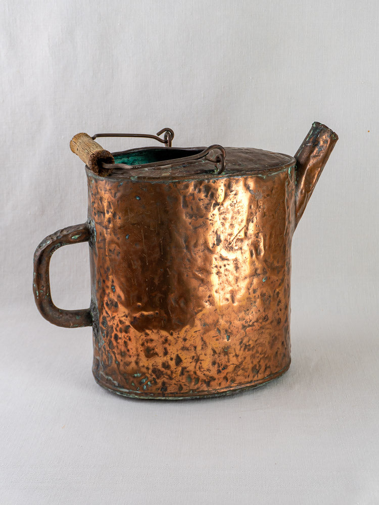 19th-century French hammered copper water carrier with side handle, spout, and lid on white background.