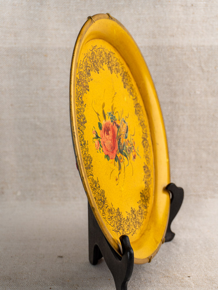 Late 19th-century French tole tray with yellow lacquer and central red rose motif on black stand.