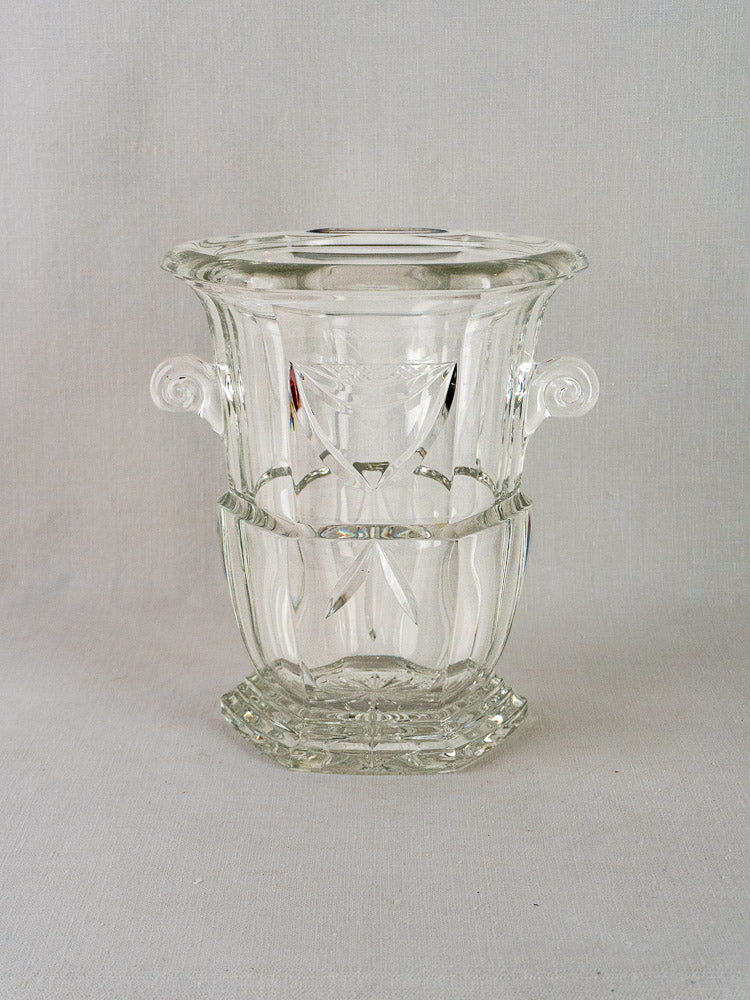 French cut crystal champagne bucket with curled handles, etched patterns, hexagonal base, light gray background.