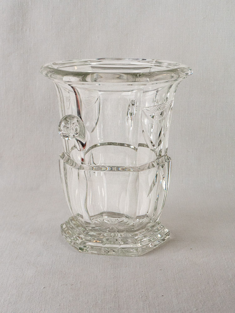 Vintage French cut crystal champagne bucket with faceted glass, flared rim, and vertical lines on light textured surface.