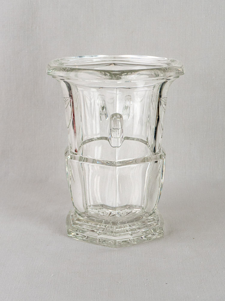 Vintage French cut crystal champagne bucket with thick faceted glass and wide flared rim on gray background.