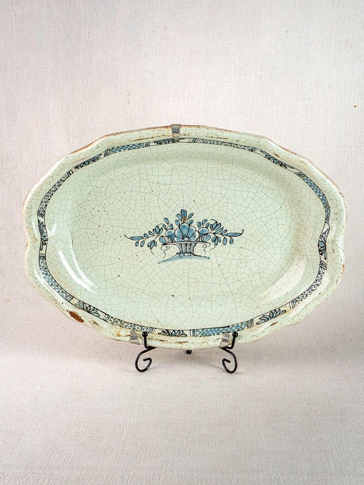 Pair of antique French Rouen-style faience platters with blue floral motifs, decorative edging, and visible glaze cracks.