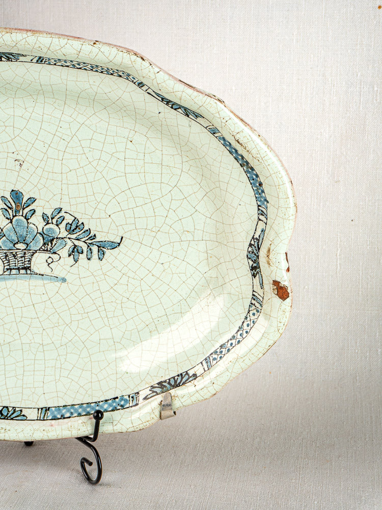 Antique French Cul Noir faience platter with blue floral design, tin-glazed earthenware, slight rim chip.