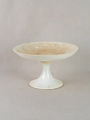 Antique French faience pedestal dish with wide shallow white craquelé ceramic bowl on narrow stem.