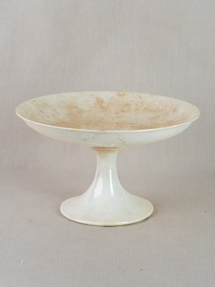 Antique French Longwy white craquelé faience compotier with wide shallow bowl and tall pedestal base.