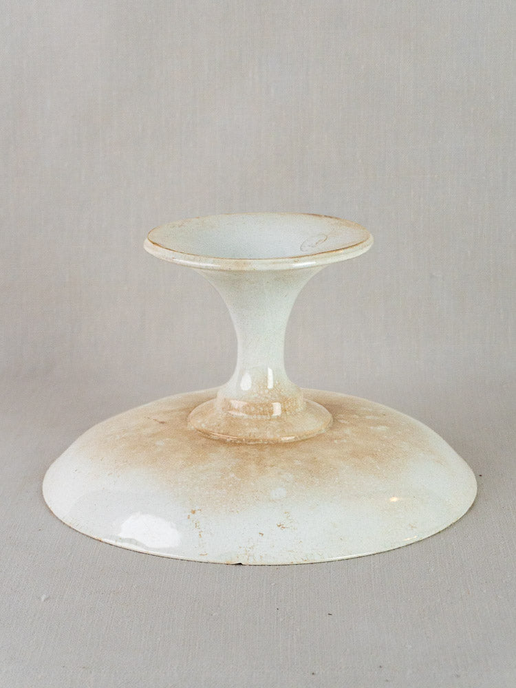 Antique French Longwy white faience compotier with craquelé glaze and aged patina on neutral background.