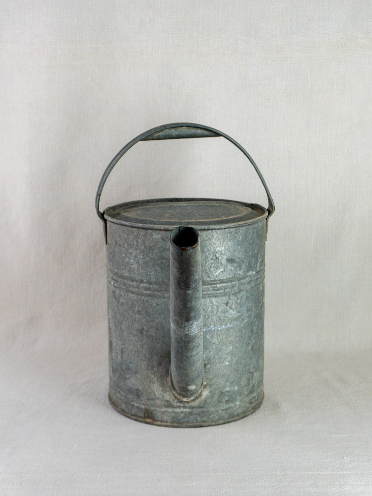French galvanized zinc long-spout garden watering can with large handle, centered on light background.