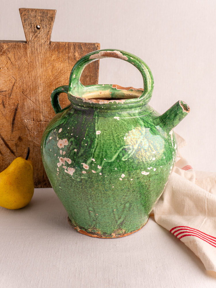 Antique French Provençal green glazed earthenware gargoulette jug with rounded body and arched handle, areas of glaze wear.