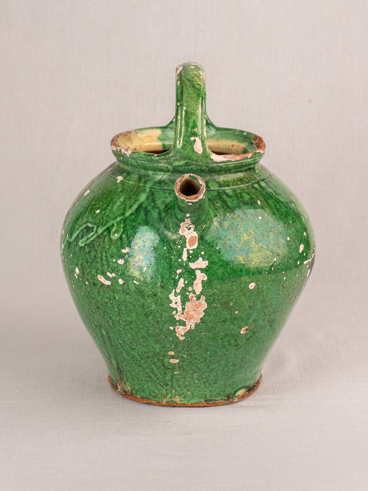 Antique French Provençal green glazed earthenware gargoulette jug with two openings, rounded body, worn glaze, curved handle.