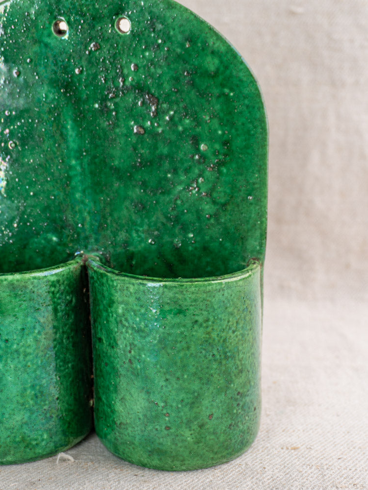 Antique French green glazed earthenware wall utensil holder with two cylindrical pockets, late 19th–early 20th century.