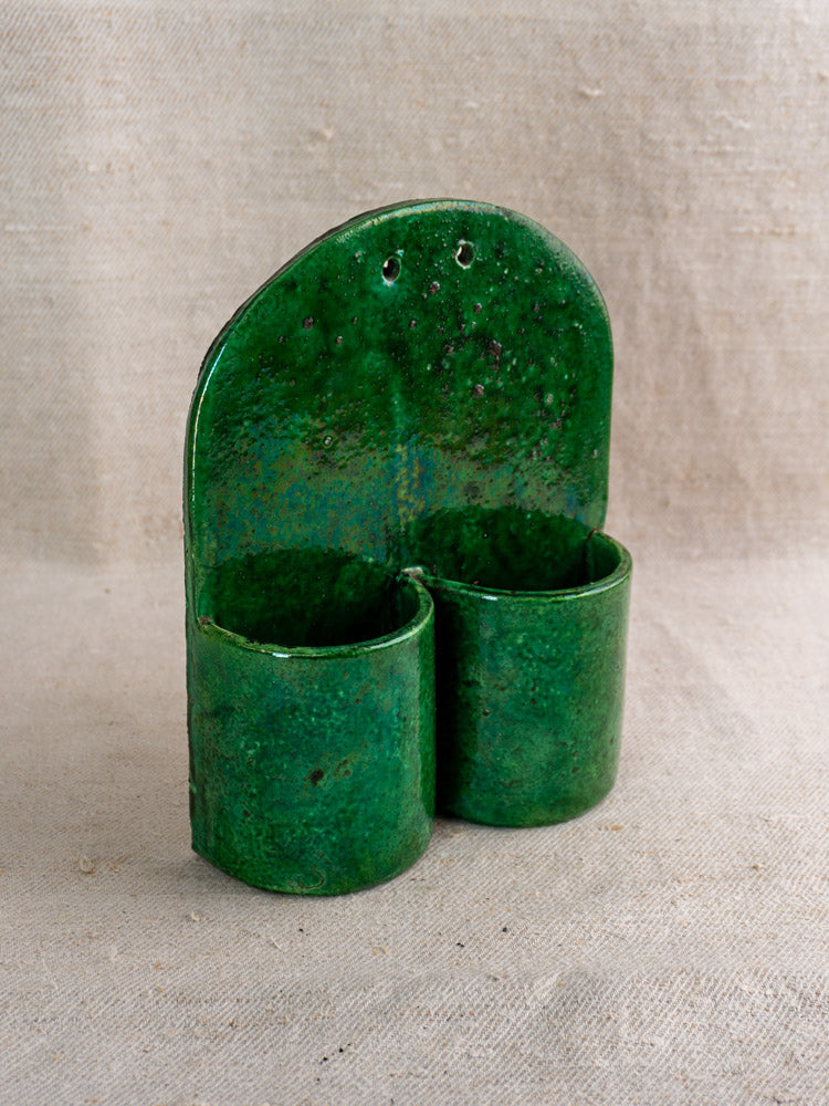 Antique French green glazed earthenware wall utensil holder with two cylindrical pockets, late 19th–early 20th century.