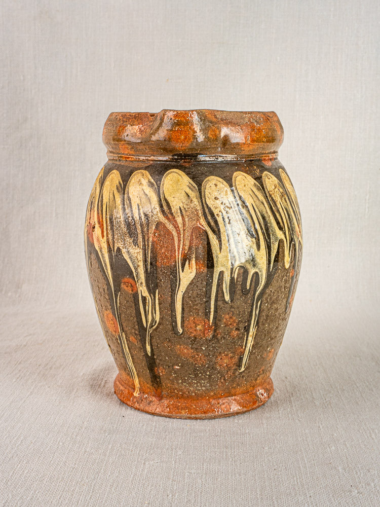 Antique French Pichet Jaspé slipware pottery vase, brown with cream glaze, neutral fabric backdrop.
