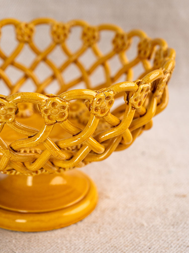 Provence Yellow Pichon Uzès woven ceramic bowl with lattice pattern and floral rim, on neutral fabric background.