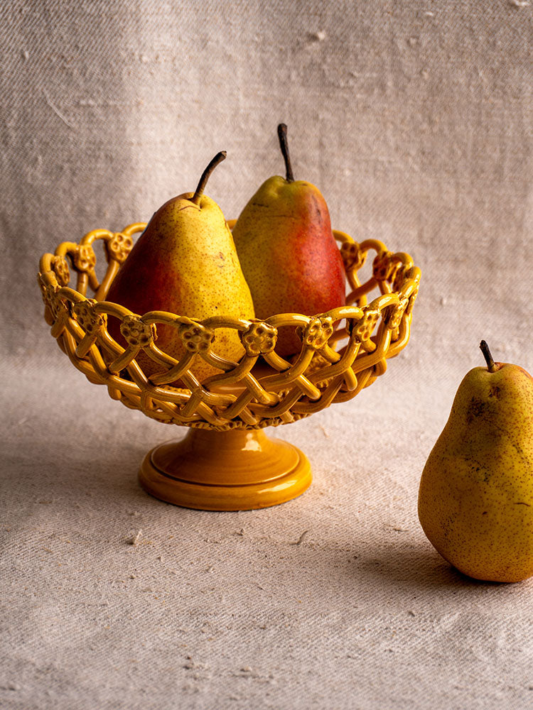Provence Yellow Pichon Uzès woven ceramic bowl with two pears, one pear resting on a neutral fabric surface.