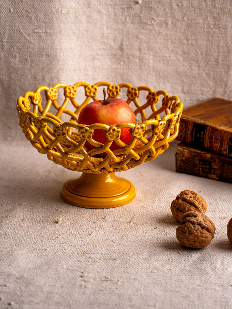 Provence Yellow Pichon Uzès woven ceramic bowl with apple, walnuts, and old books on textured fabric background.