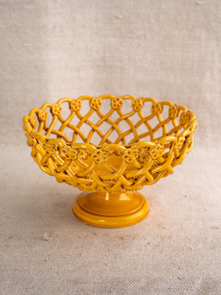 Provence Yellow Pichon Uzès woven ceramic bowl with intricate lattice design on a neutral textured fabric background.