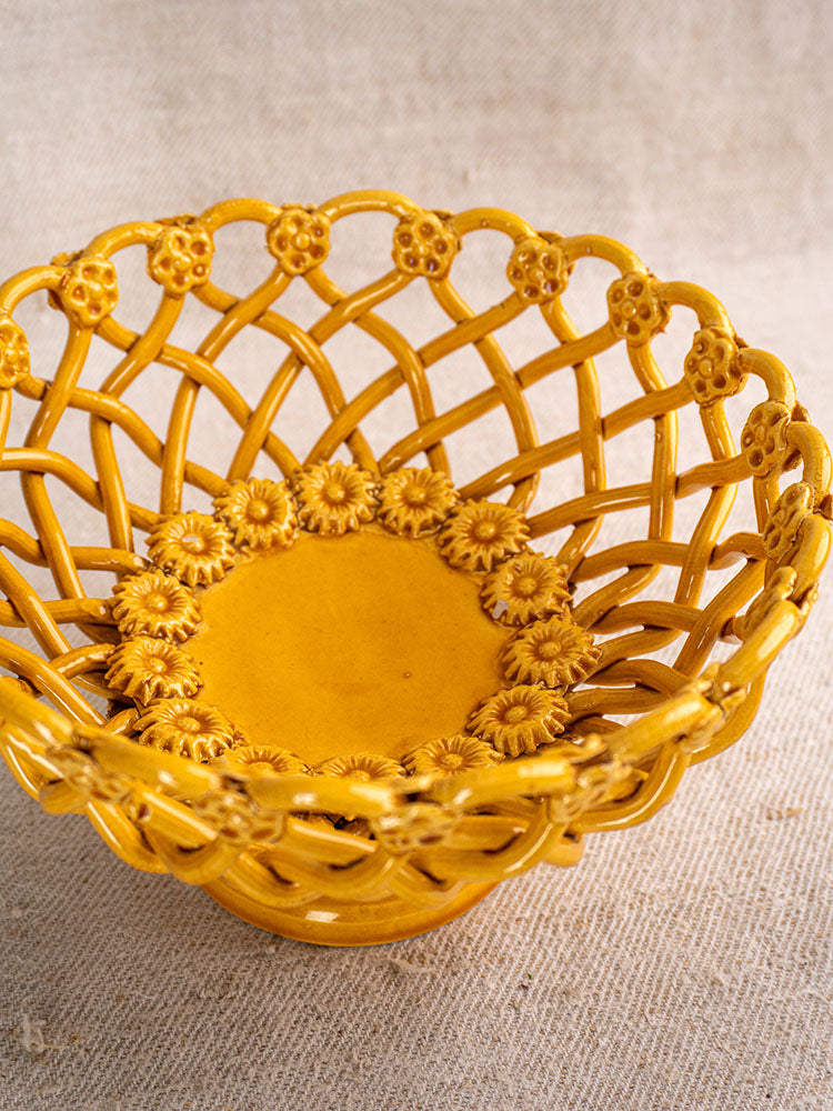 Provence Yellow Pichon Uzès woven ceramic bowl with handmade lattice and floral motifs on beige textured fabric.