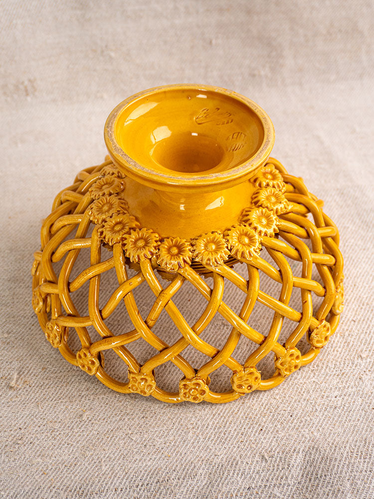 Provence yellow Pichon Uzès ceramic bowl with lattice design and floral rim, shown on textured beige fabric.
