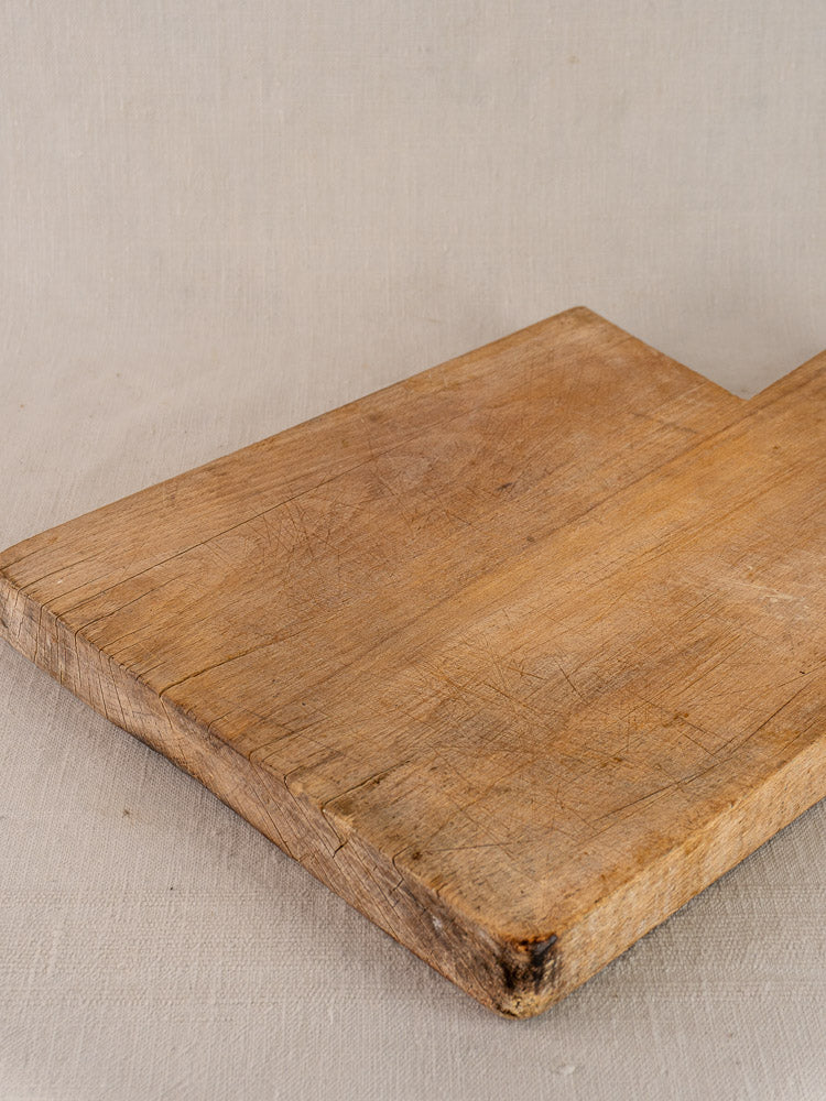 Antique French hardwood cutting board in Provencal style, rustic rectangular shape with visible wear, displayed on a neutral background.